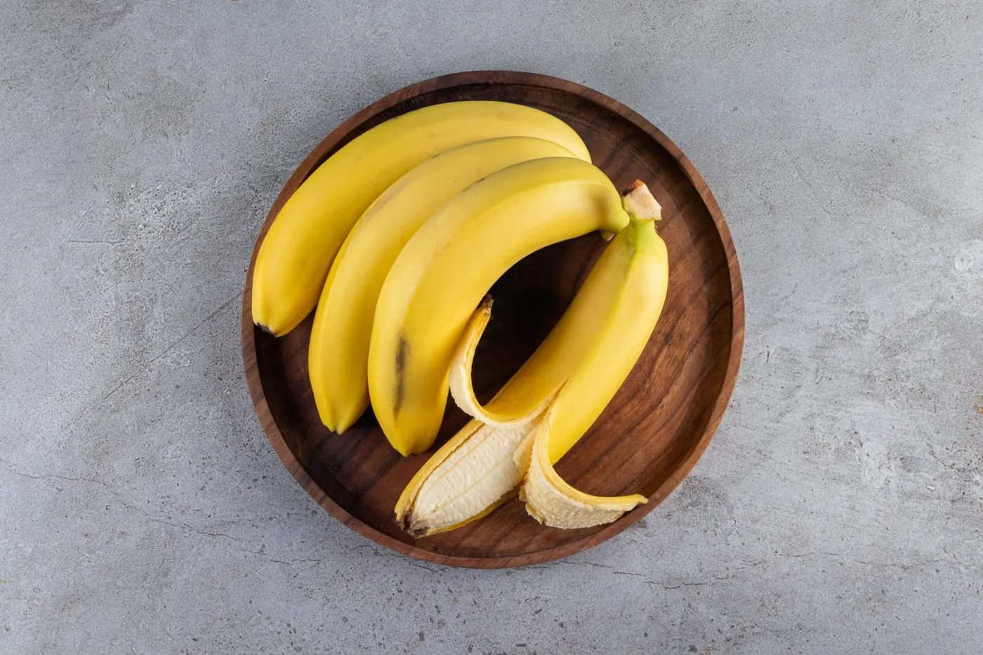 Ripe yellow bananas on a stone table